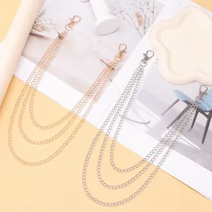 Detailed view of triple-layered metallic pants chains in gold and silver with lobster clasps
