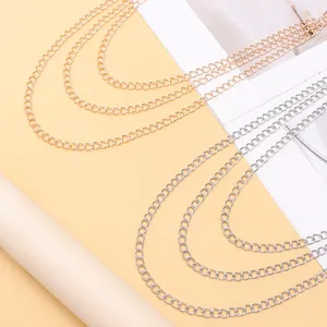 Close-up detail of multi-layer gold and silver metal chain links for fashion pants and jeans