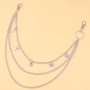 Detailed view of triple-layered silver pant chain featuring festive Christmas charms