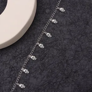 Detail of silver skull boot chain accessory with metal charms for punk footwear