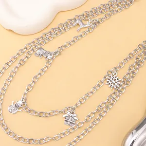 Close-up of layered silver metal chain featuring reindeer, snowflake and snowman charms