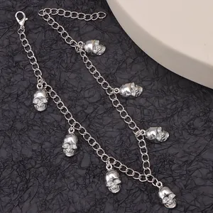 Punk style silver chain boot accessory featuring six detailed skull pendants and lobster clasp