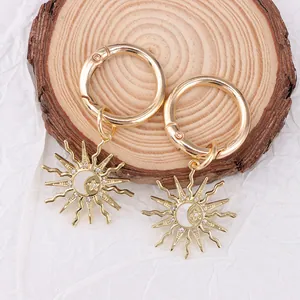 Detailed close-up of golden sun and moon boot charms with sparkling rhinestones decoration