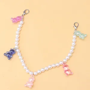 Close-up of pearl bead chain with five colorful resin bears and silver lobster clasps