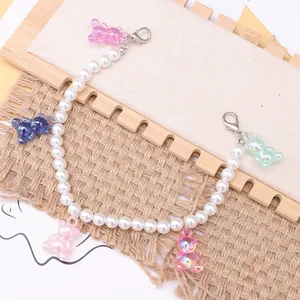 Detailed macro view of pearlescent colorful resin bears and pearl shoe chain accessories