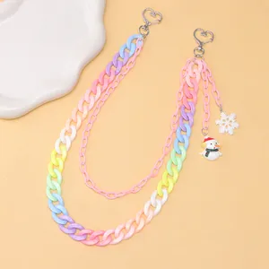 Detail of colorful acrylic pant chain with snowman and snowflake charms and heart clip