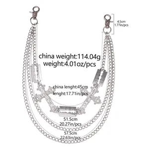 Detailed view of silver punk pants chain with cross pendants and razor blade charms