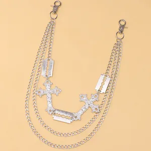 Detail of silver multilayer pant chain with hollow cross and blade charms in punk style