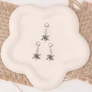 Macro detail of vintage silver hexagram crown charms with lobster clasps for shoes
