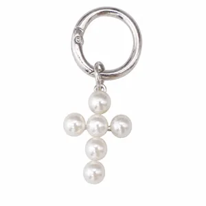 Close-up of gothic pearl cross pendant with dimensions and silver metallic ring detail