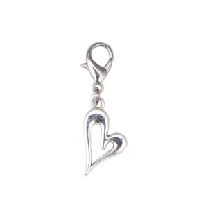Detailed view of heart-shaped hollow pendant with lobster clasp for fashion boots