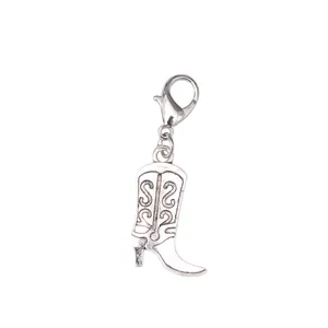 Detailed view of silver western cowboy boot charm with vintage swirl engraving pattern