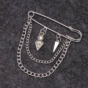 Detailed punk safety pin brooch with hanging silver metal chains and geometric pendants