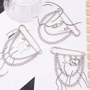 Three styles of silver fashion lock and key safety pin brooches with layered metal chains