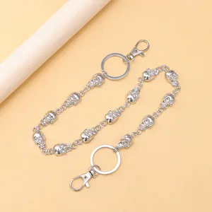 Close-up of punk style silver metal trousers chain with detailed skull links