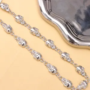 Close-up of hip hop skull waist chain with polished silver metal links and gothic style