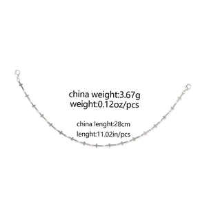 Detail view of silver cross chain accessory measuring 28cm with lobster clasp closure