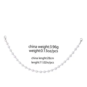 Detailed view of 28cm pearl chain accessory with metal lobster clasps and spike charms