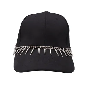 Detail of silver metal chain and punk cone spikes on a black twill baseball cap visor