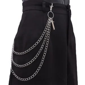 Detail einer silbernen dreilagigen Metall-Hosenkette mit Kreuzanhänger an schwarzer Hose