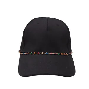 Close-up of black cotton baseball cap with bohemian colorful beaded chain decoration