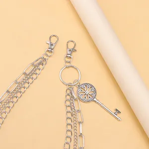 Detail einer silbernen mehrlagigen Metall-Hosenkette mit Retro-Schlüsselanhänger