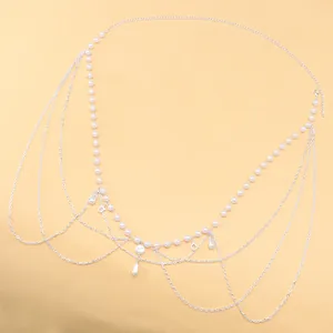 Detail of multi-layer pearl waist chain with metal fringe and teardrop pendants