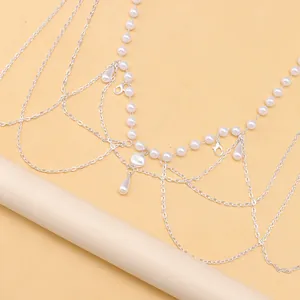 Detail view of multilayer pearl waist chain with silver fringe tassels and lobster clasp