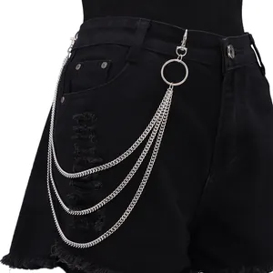 Close-up of triple-layered silver punk waist chain with rings on black denim shorts