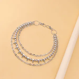 Detail of three-layer silver punk metal trouser chain with studs and bead links