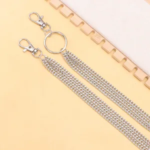 Detailed macro shot of multi-layer silver hip hop metal chains with ring and lobster clasp