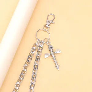 Detail of silver double chain with gothic skull spine and cross screw pendant