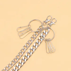 Detail of silver metal waist chain featuring lobster clasps and rings for accessories