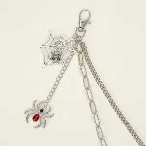 Close-up of hip-hop waist chain with silver spider web pendant and red crystal spider detail