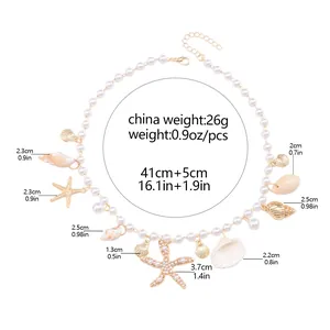 Detail view of shell and starfish charms on a pearl beach necklace with size dimensions