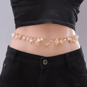 Detail of bohemian gold waist chain with sea shells, starfish pendants and pearls