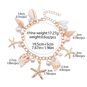 Detail of gold beach charm bracelet with shells, starfish, pearls and size dimensions