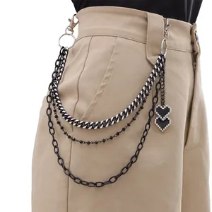 Detail of layered metal trousers chain with pixel heart charms and lobster clasps