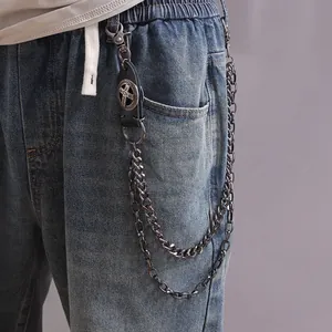 Close-up of a double-layer metal pants chain with black leather cross-embossed detail