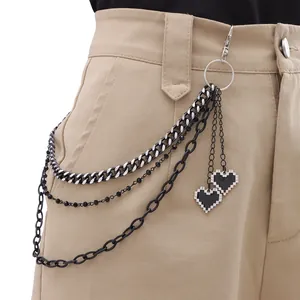 Multi-layer street style belt chain with pixel heart pendants on khaki trousers