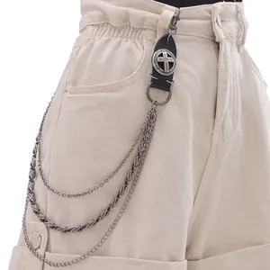 Close-up of triple-layered punk trouser chain with leather cross patch detail