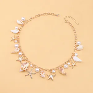 Detail of bohemian necklace with sea shells, faux pearls and gold starfish charms
