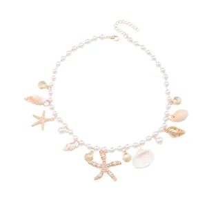Summer beach pearl necklace featuring golden seashell, starfish, and conch pendants