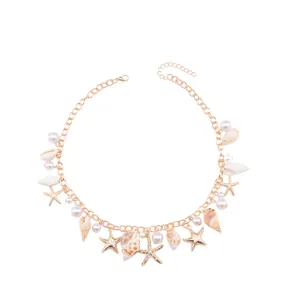 Detail of adjustable gold necklace with seashell pendants, starfish and pearls