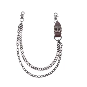 Detail of double-layer metal chain with punk cross leather patch for jeans and belts