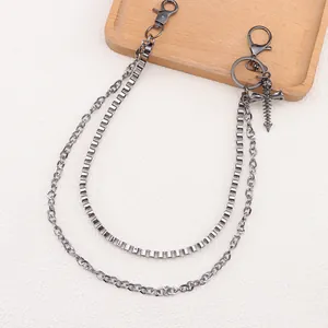 Punk multilayer metal pant chain with cross pendant and skull detail on off-white background