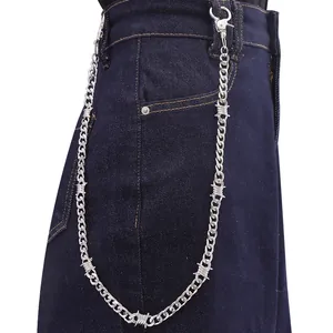 Silver punk style waist chain with metal thorn accents on dark denim pants