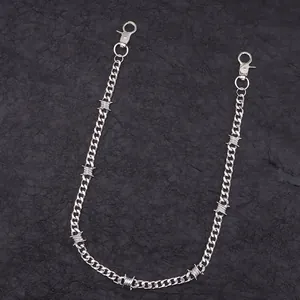 Close-up of silver zinc alloy pant chain with edgy thorn links on black background