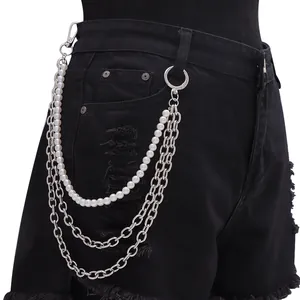Detail of triple-layer pants chain featuring white pearls and silver metal link chains