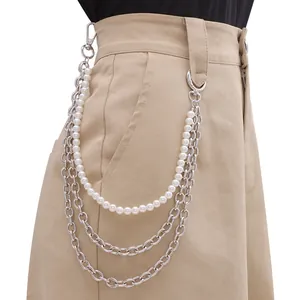 Close-up of layered hip-hop trousers chain with silver links and white pearls on pants